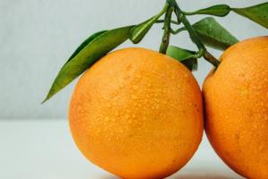 two orange fruits on table
